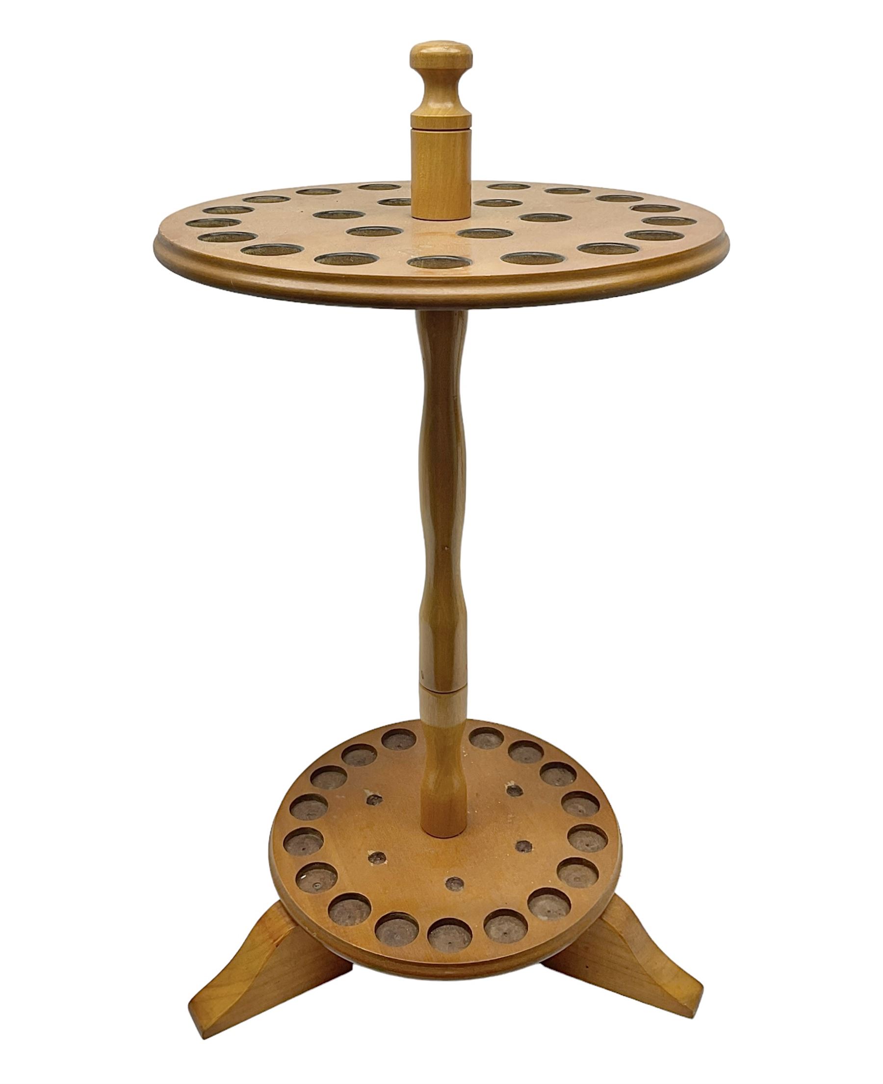 Pine stick stand, with turned central column dividing two circular tiers, upon three feet, with capacity for twenty four walking sticks, H73cm