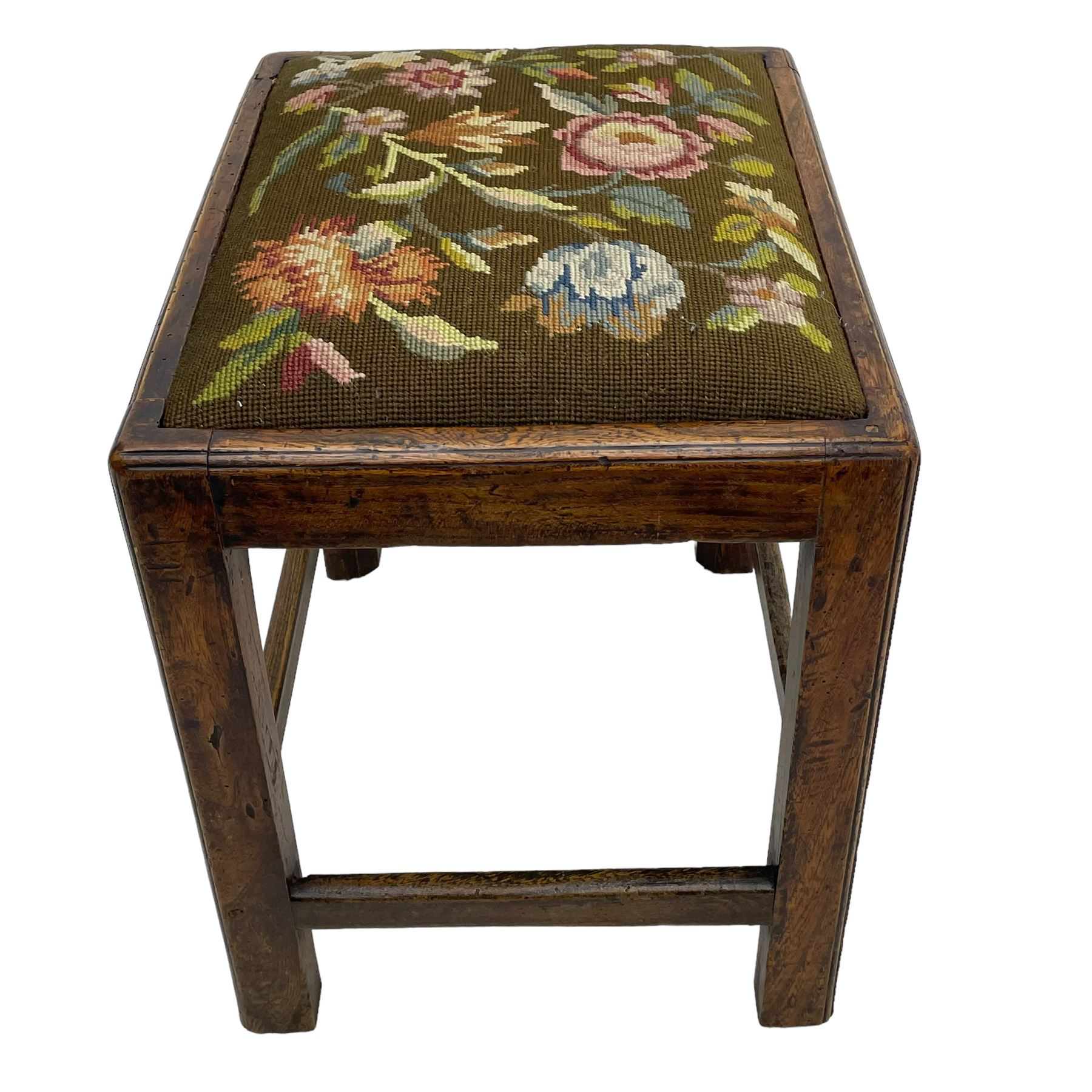 19th century country elm stool, rectangular form with drop-in seat upholstered in floral needlework, moulded frame and supports, united by plain stretchers 