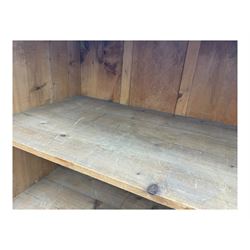 Large 19th century pine cupboard, rectangular top over two panelled later doors, enclosing four open shelves, on plinth base