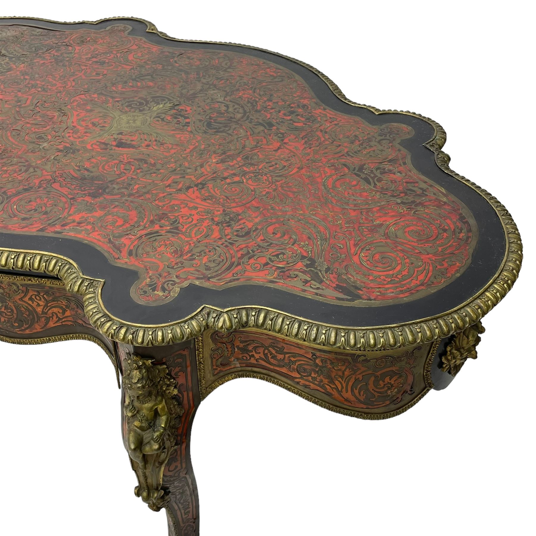 Victorian Louis XV design boulle work centre table, shaped form, decorated extensively with brass and red tortoise shell scroll work, central extending acanthus leaves surrounded by scrolling foliage, gardroon and floral cast brass edge, the frieze rails decorated with further boulle work and green man gilt metal cast masks, the cabriole supports mounted by seated putti mounts on S-scroll brackets surrounded by oak leaves and acorns, ornate scroll and floral cast terminal caps