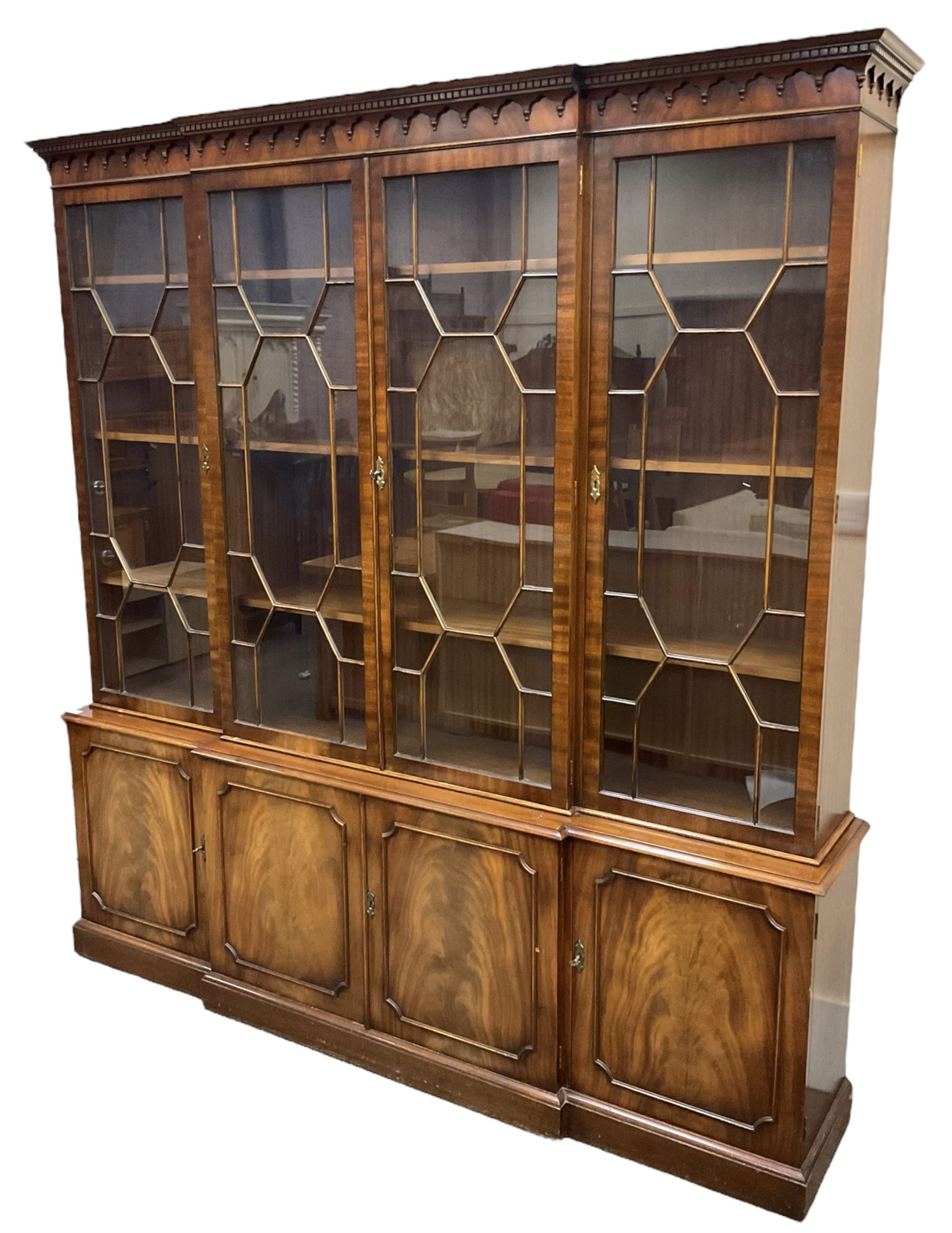 Bevan Funnell - Georgian design mahogany breakfront bookcase, moulded dentil and arcaded frieze over four astragal glazed doors, four cupboards below enclosed by figured doors, on skirted base