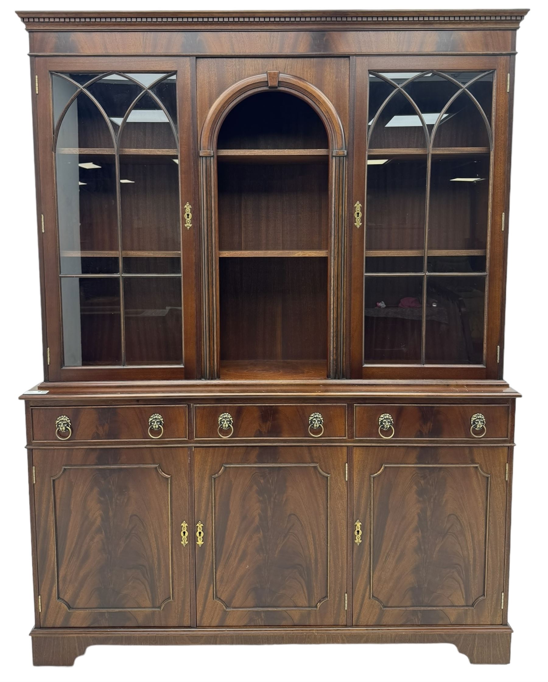 Georgian design mahogany bookcase on cupboard, projecting moulded and dentil cornice, two display cabinets enclosed by glazed doors above over three drawers and three cupboards, on bracket feet