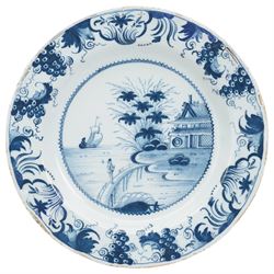 18th century English Delft charger, painted in blue with a Chinese scene with a figure in ...