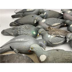 Fourteen Wood Pigeon decoys, together with camouflage netting