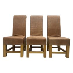 Set of six contemporary light oak dining chairs, each with high back and seat upholstered in pale tan leather, on square supports connected by H-stretcher