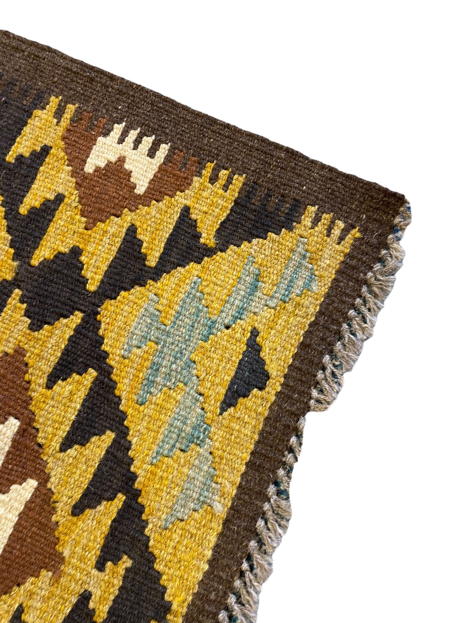 Chobi Kilim multi-colour runner rug, the field decorated with geometric lozenges in contrasting shades on brown ground