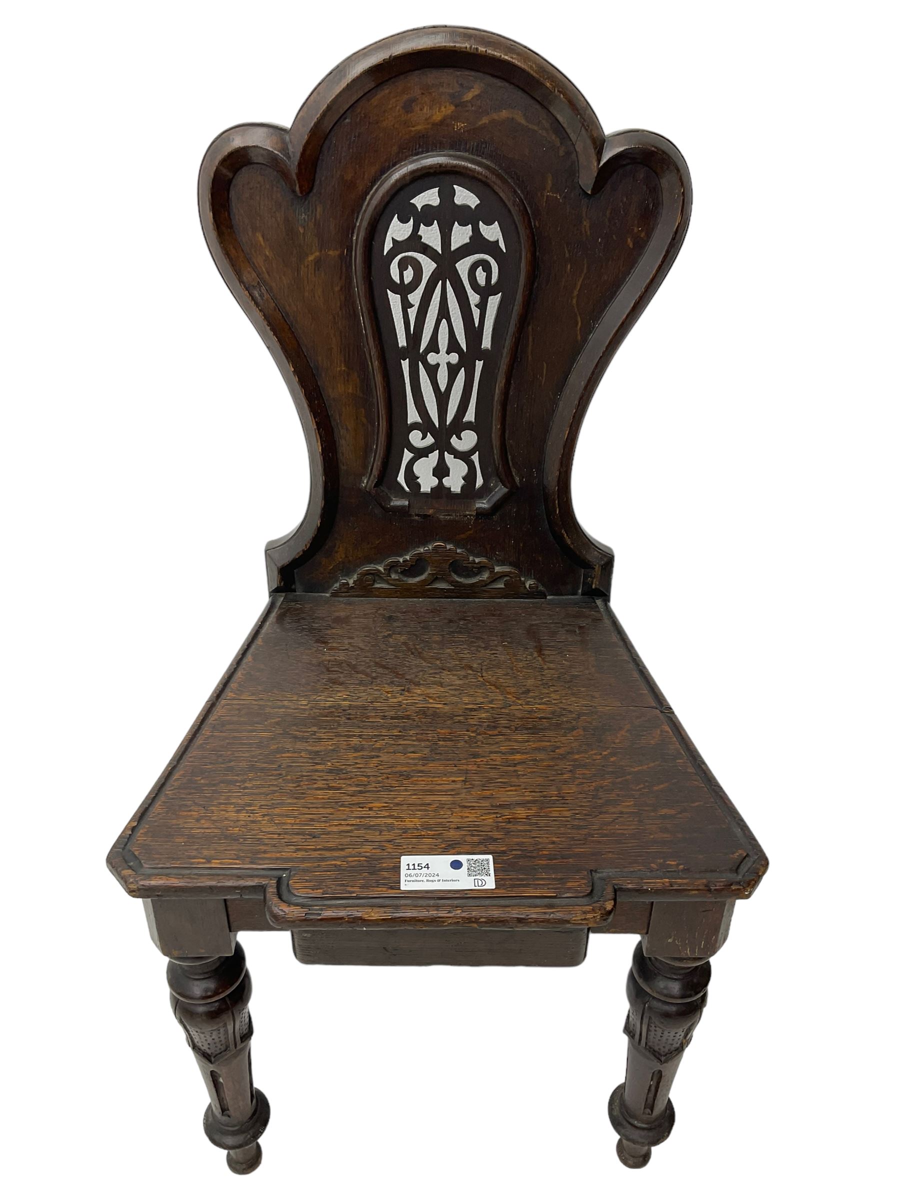 Victorian oak hall chair, the shaped back with fretwork splat, stepped moulded seat on turned lappet supports with fluting 