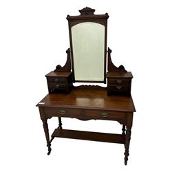 Late Victorian walnut dressing table, raised bevelled swing mirror over small trinket drawers, rectangular moulded top, fitted with two drawers, on turned supports united by undertier 