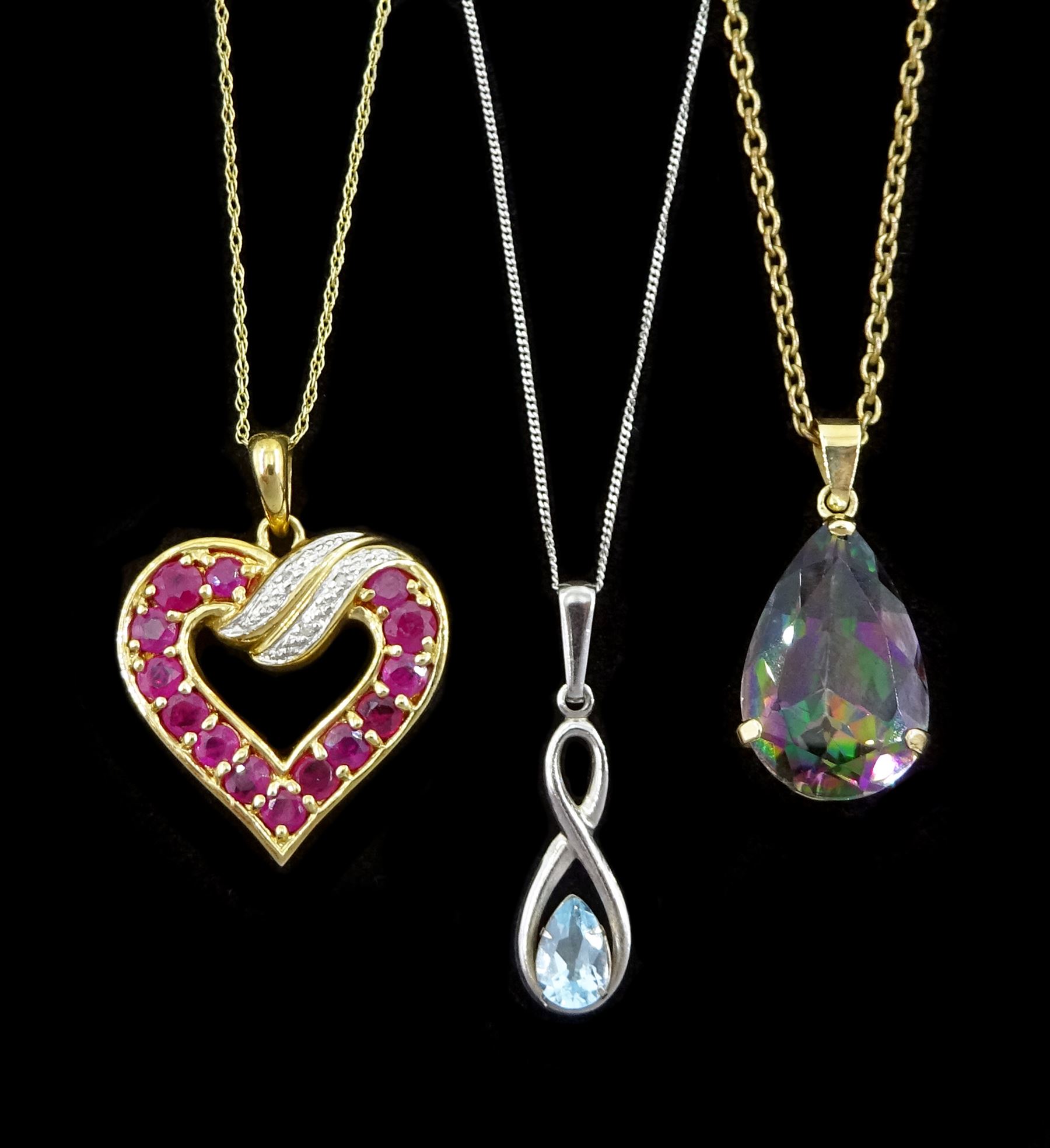 White gold single stone blue topaz pendant necklace, ruby and diamond pendant necklace and a gold mystic topaz pendant, all 9ct, on a gilt chain