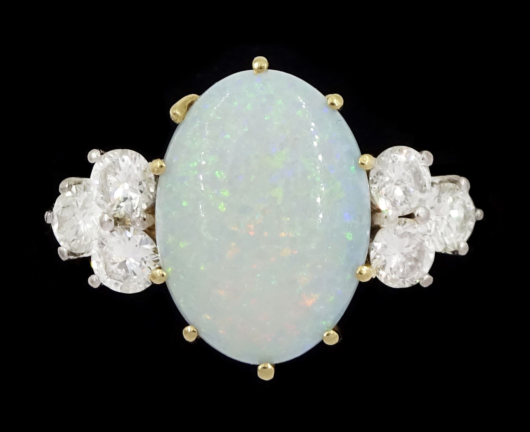 18ct gold opal and six stone round brilliant cut diamond ring, London 1977, opal approx 2.60 carat, total diamond weight approx 0.65 carat