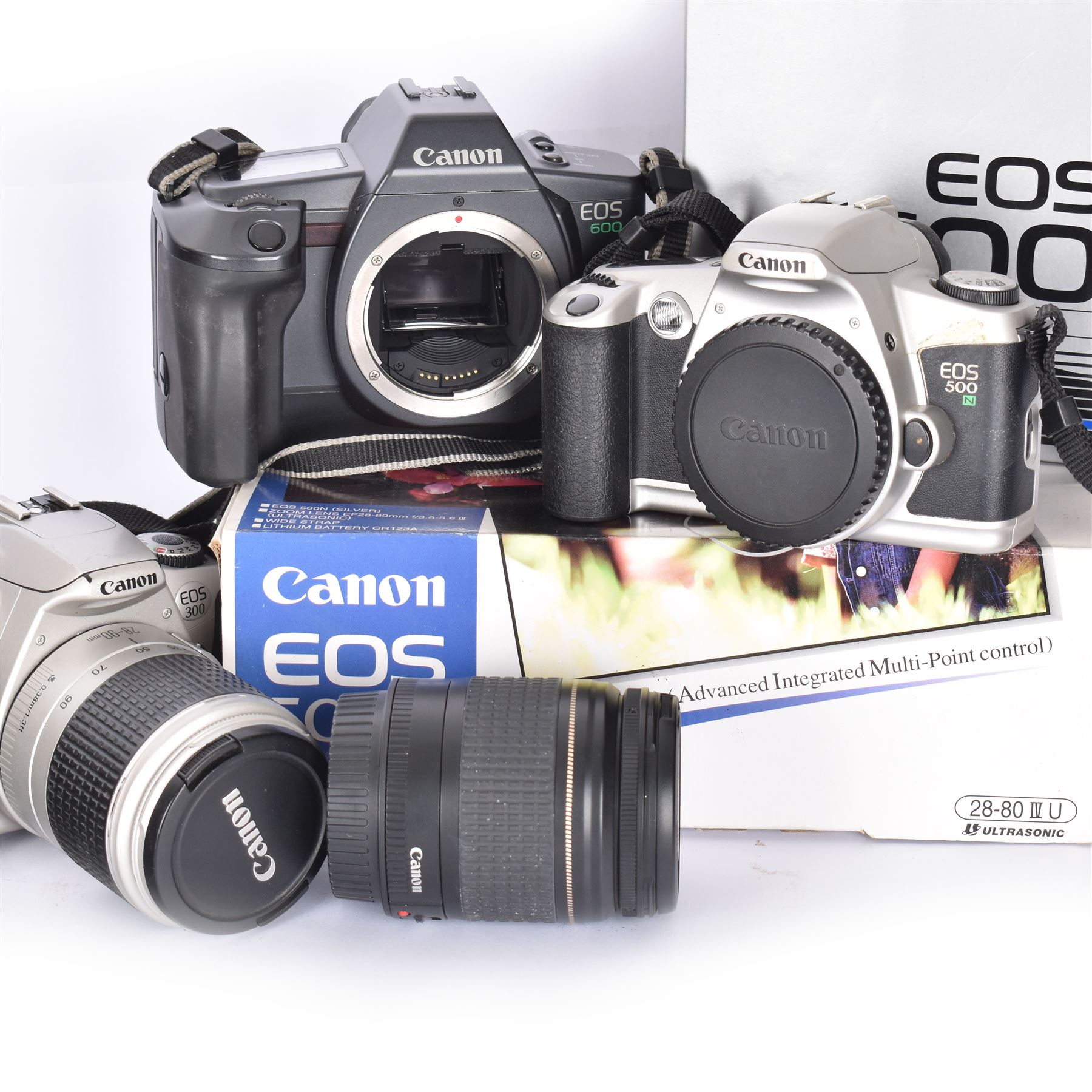 Three Canon EOS cameras, comprising EOS 500N Silver Kit, serial no. 9660130 with Canon EF 28-80mm 1:3.5-5.6 IV zoom lens, serial no. 9505171, EOS 300 with Canon EF 28-90mm 1:4-5.6 zoom lens, serial no. 5828460, and a Sigma 28-300mm 1:3.5-6.3 macro zoom lens, serial no. 1027931 and an EOS 600 camera body, serial no. 2651130, two boxed and one in carry case