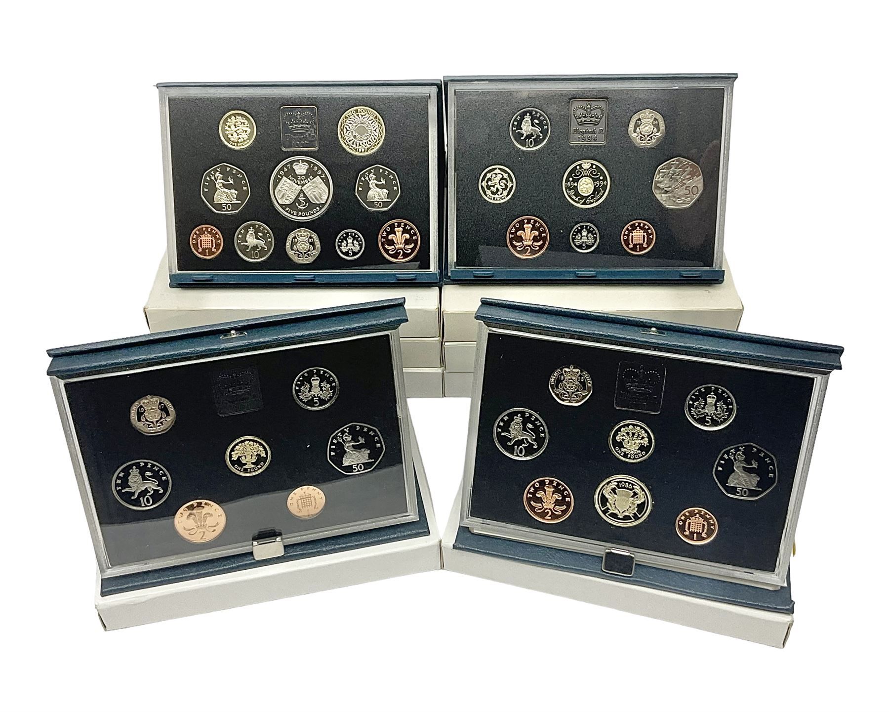 Ten The Royal Mint United Kingdom proof coin collections, dated 1983, 1984, 1985, 1986, 1987, 1992, 1994, two 1997 and 1998 all in blue folders with certificates