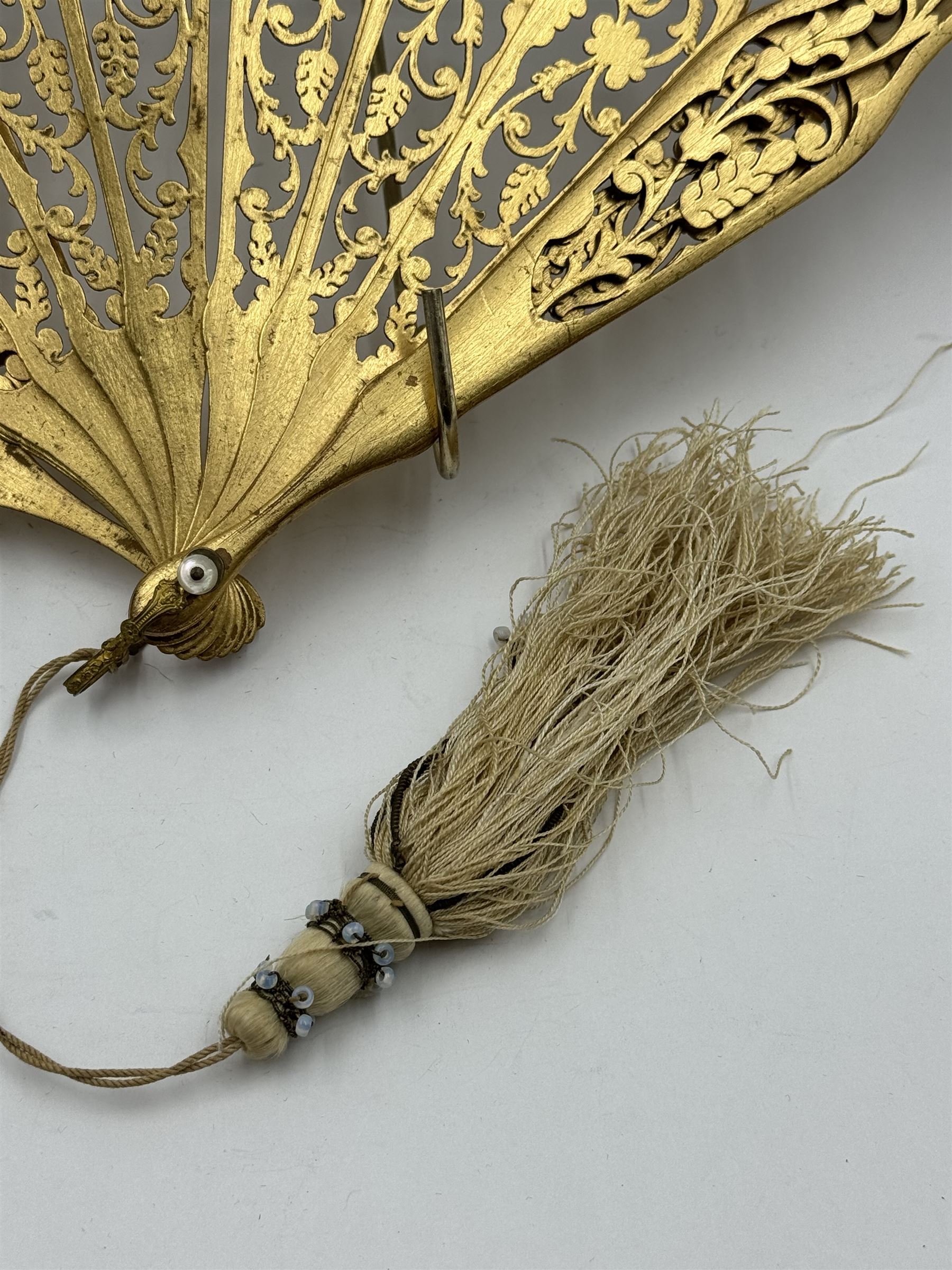 19th century carved gilt wood fan by Eugene Rimmel, the guards and sticks with pierced floral decoration, the chiffon leaf worked with sequins, with silk beaded tassel, stamped E.Rimmel 36 Strand London, with a purple silk lined box 