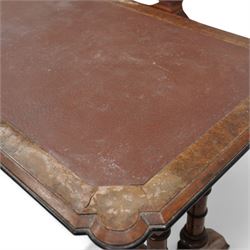 Late 19th century Aesthetic Movement inlaid walnut library table, shaped rectangular top with moulded and banded edge, inset with oxblood leather writing surface, fitted with two frieze drawers, raised on ring turned twin-pillar end supports with carved acanthus capitals terminating to arched supports with ebony inlay, united by turned stretcher 