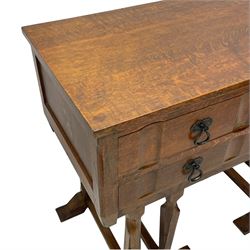 Arts & Crafts design oak chest on stand, rectangular top over two short and one long drawer, on a series of shaped and tapered supports with carved and beaded decoration, united by chamfered stretchers rails, on sledge feet 