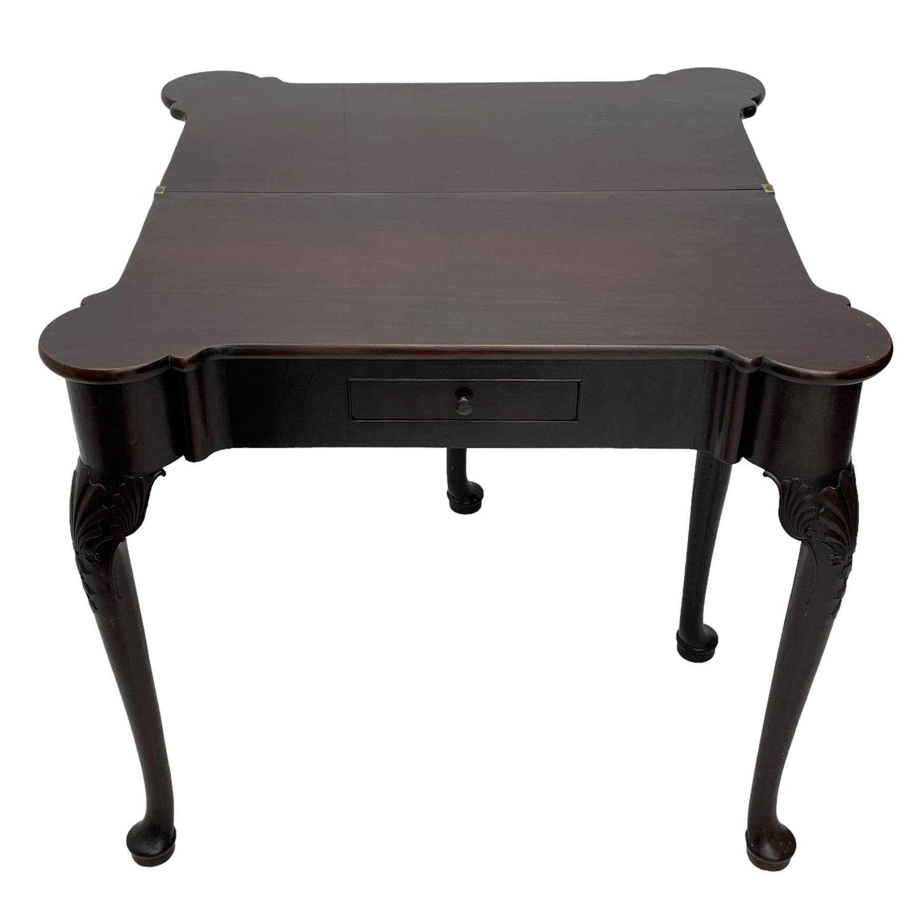 Late 18th century Irish mahogany tea table, rectangular form with projecting stepped rounded corners, fold-over action top over single frieze drawer within cock-beaded surround, on shell and bellflower carved cabriole supports, single gate-leg action base 