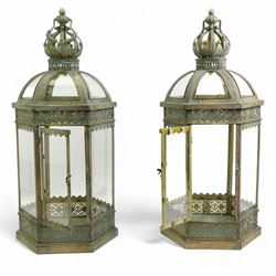 Pair of patinated brushed brass lanterns, of domed hexagonal form, with pierced gallery and swing handle, H63cm 