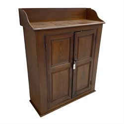 Victorian pine cupboard in scumbled oak finish, the raised back over chamfered rectangular top, enclosed by two panelled doors, the interior fitted with two shelves
