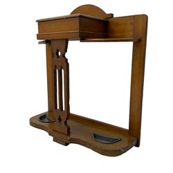 Arts & Crafts period golden oak hallstand, central glove compartment with moulded hinged top, over a Gothic pierced splat, flanking curved umbrella or stick stands