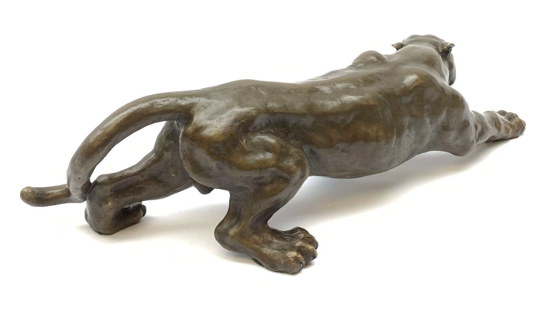 A bronze figure, modelled as a cougar in crouching pose, signed Milo and with foundry mark, L40cm. 