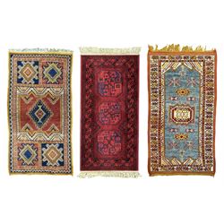 Persian Qashqai crimson ground rug, the field with central indigo and yellow medallion with geometric motifs, flanked by smaller medallions, border with repeating patterns (112cm x 200cm); Turkish Kazak light blue ground rug (109cm x 193cm); red ground runner with three octagonal medallions (69cm x 138cm)