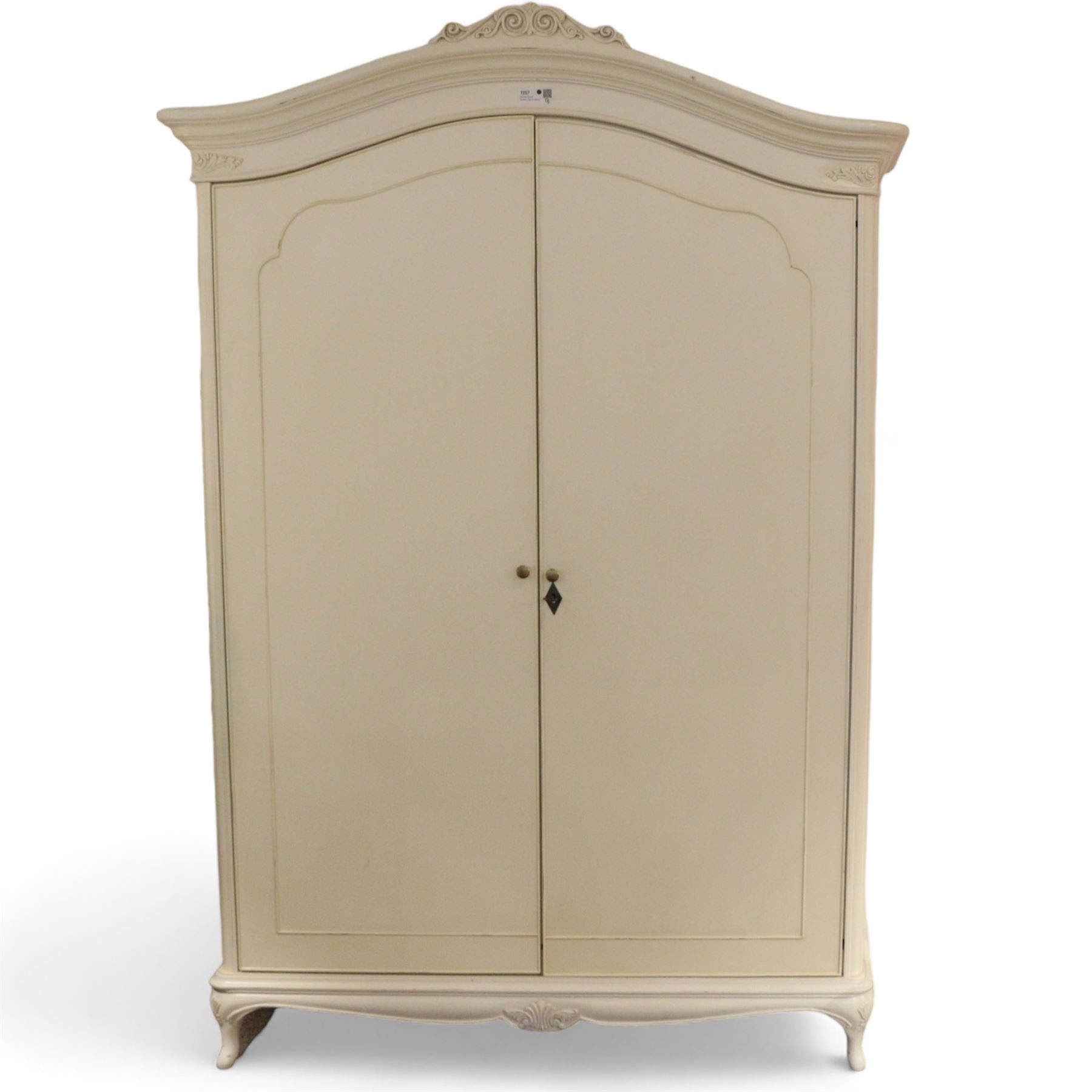 French design cream painted Armoire, foliate scroll decorated pediment over two doors, fitted with hanging rails and shelves, on cabriole feet