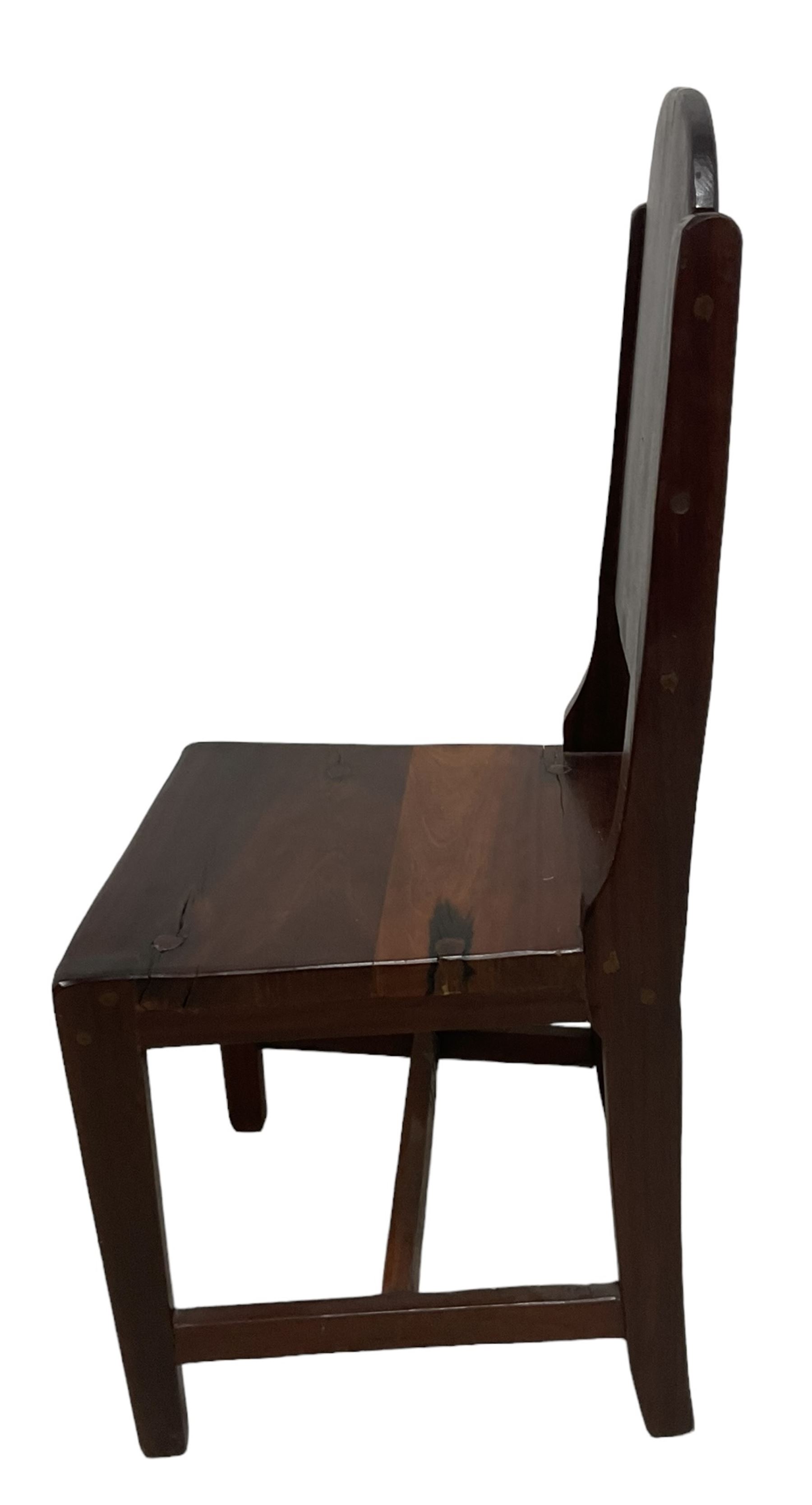 Mid-to-late 20th century teak dining table, rectangular top with canted corners, on square tapering supports with spade feet (214cm x 119cm, H76cm); and a set of eight Burmese reclaimed teak dining chairs, high arched back over panelled seat