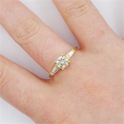 18ct gold single stone round brilliant cut diamond ring, with tapered baguette diamond shoulders, stamped 750, principal diamond approx 0.65 carat, total diamond weight approx 0.85 carat