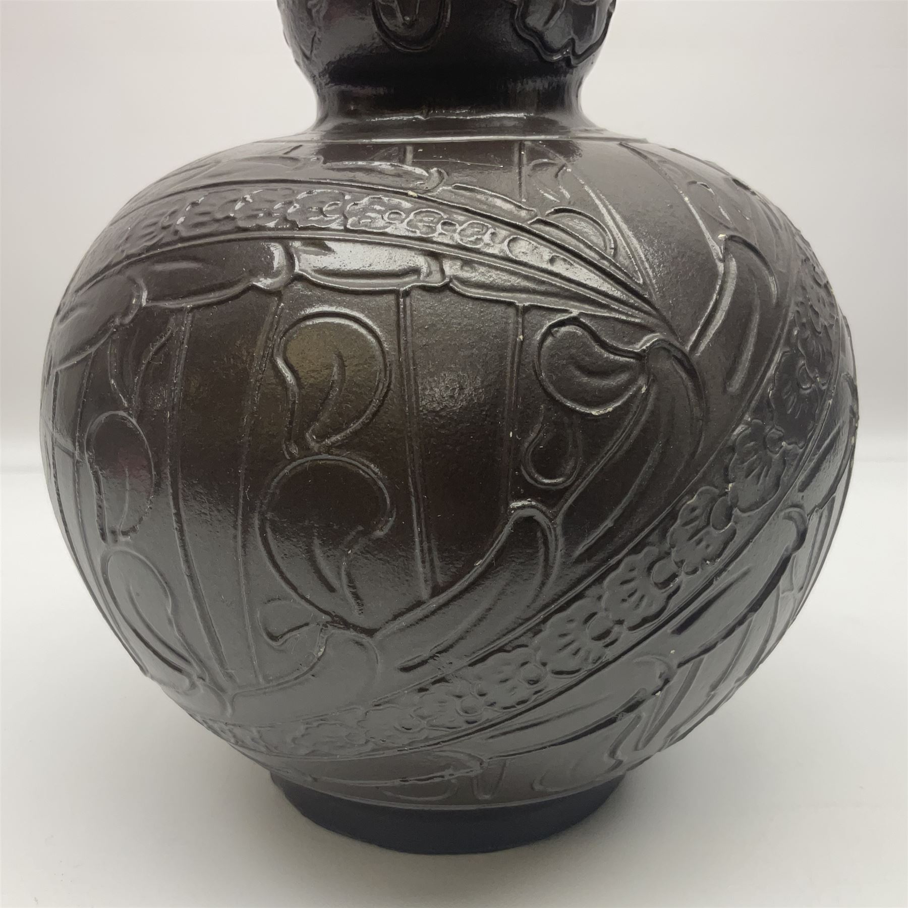 Burmantoft vase with slender neck, tubeline decoration on a brown ground, with impressed mark beneath, H38cm