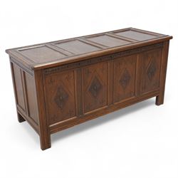 Late 20th century oak blanket chest, panelled lid over panelled front decorated with lozen...