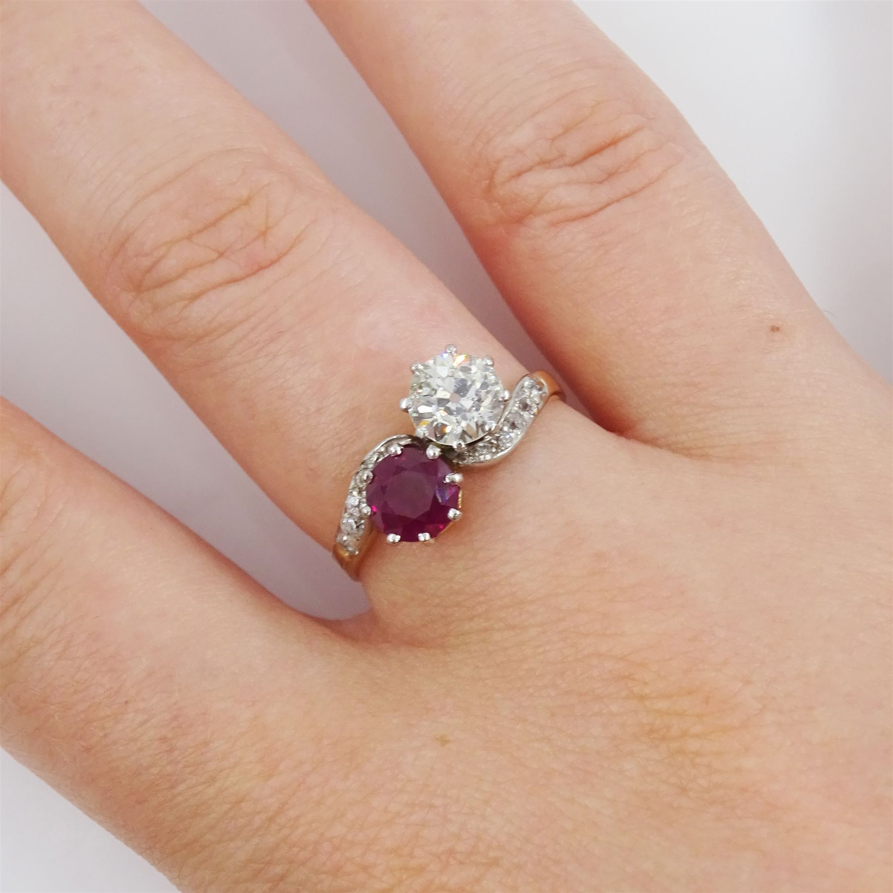 Early 20th century gold old cut diamond and ruby crossover ring, with diamond set shoulders, stamped 18ct, diamond approx 0.70 carat, ruby approx 0.75 carat