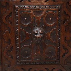 19th century Jacobean Revival heavily carved oak side cabinet, rectangular top with moulded edge, the frieze drawer applied with a central green man carved handle and surrounded scrolled acanthus leaves, over two panelled cupboards with egg-and-dart and rosette motifs with central lion mask mounts, flanked by uprights with further lion masks over protruding fruit and floral vines, lower moulded edge on square feet