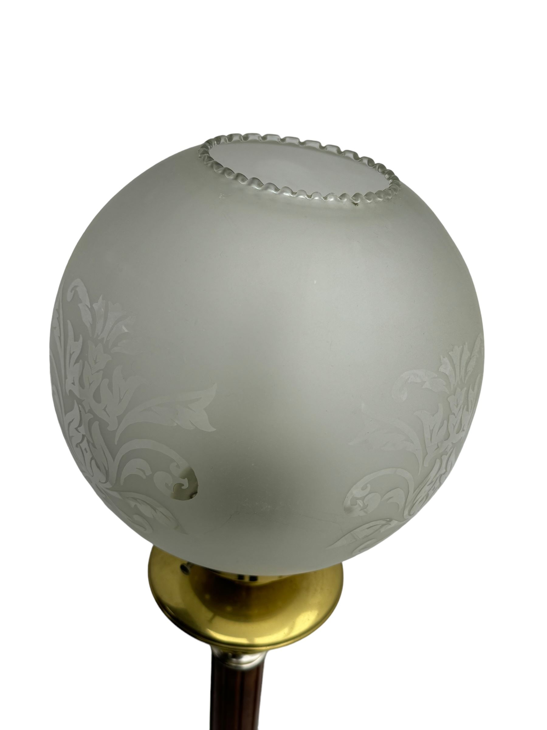 Victorian brass and wood standard lamp, frosted glass globe shade with etched floral design, brass collar above reeded wooden column with metal spacers, on circular brass base with fluted decoration