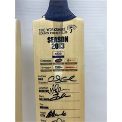 Two signed Yorkshire County cricket bats, from 2013 and 2014 seasons, bearing signatures including Johnny Bairstow, Joe Root, Tim Bresnan, Andrew Gale, etc