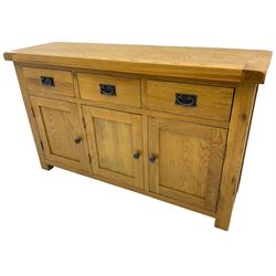 Contemporary light oak sideboard, fitted with three drawers over three panelled cupboards enclosing shelving, on square supports