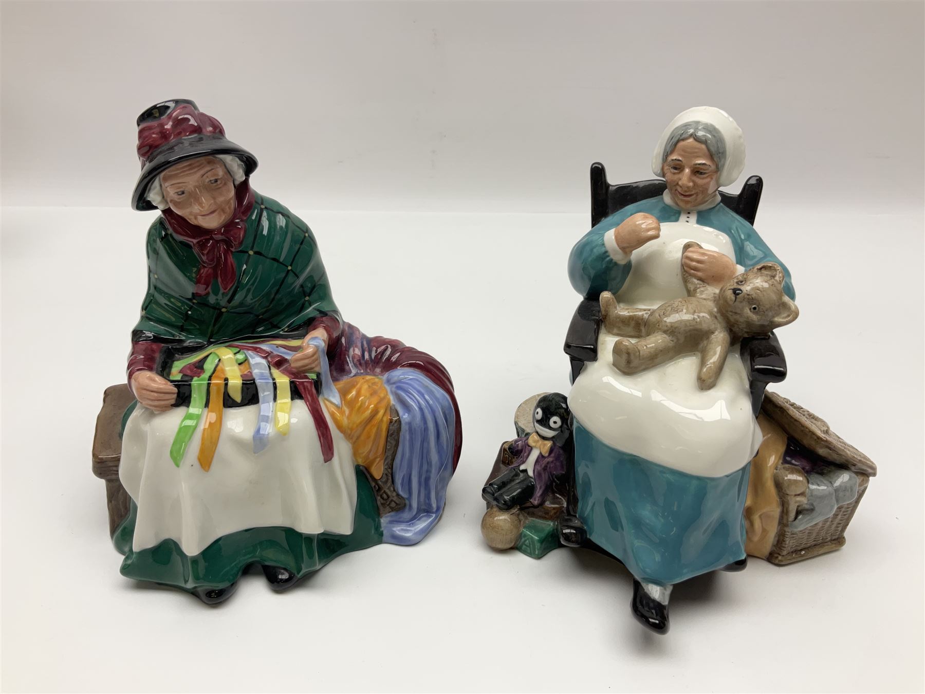 Five Royal Doulton figures, comprising The Balloon Man HN1954, Silks and Ribbons HN2017, Embroidering HN2855, Nanny HN2221 and Rest Awhile HN2728 