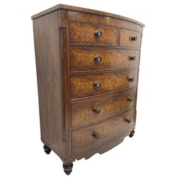 Tall Victorian mahogany bow-front chest, fitted with two short over four long cock-beaded drawers, with turned handles, canted upright corners with quarter columns, shaped apron, on turned feet