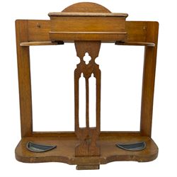 Arts & Crafts period golden oak hallstand, central glove compartment with moulded hinged top, over a Gothic pierced splat, flanking curved umbrella or stick stands