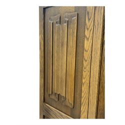 Jacobean design oak double wardrobe, projecting cornice over Gothic arched tracery carved frieze, twin panelled doors with linenfold relief carved detailing, on plinth base