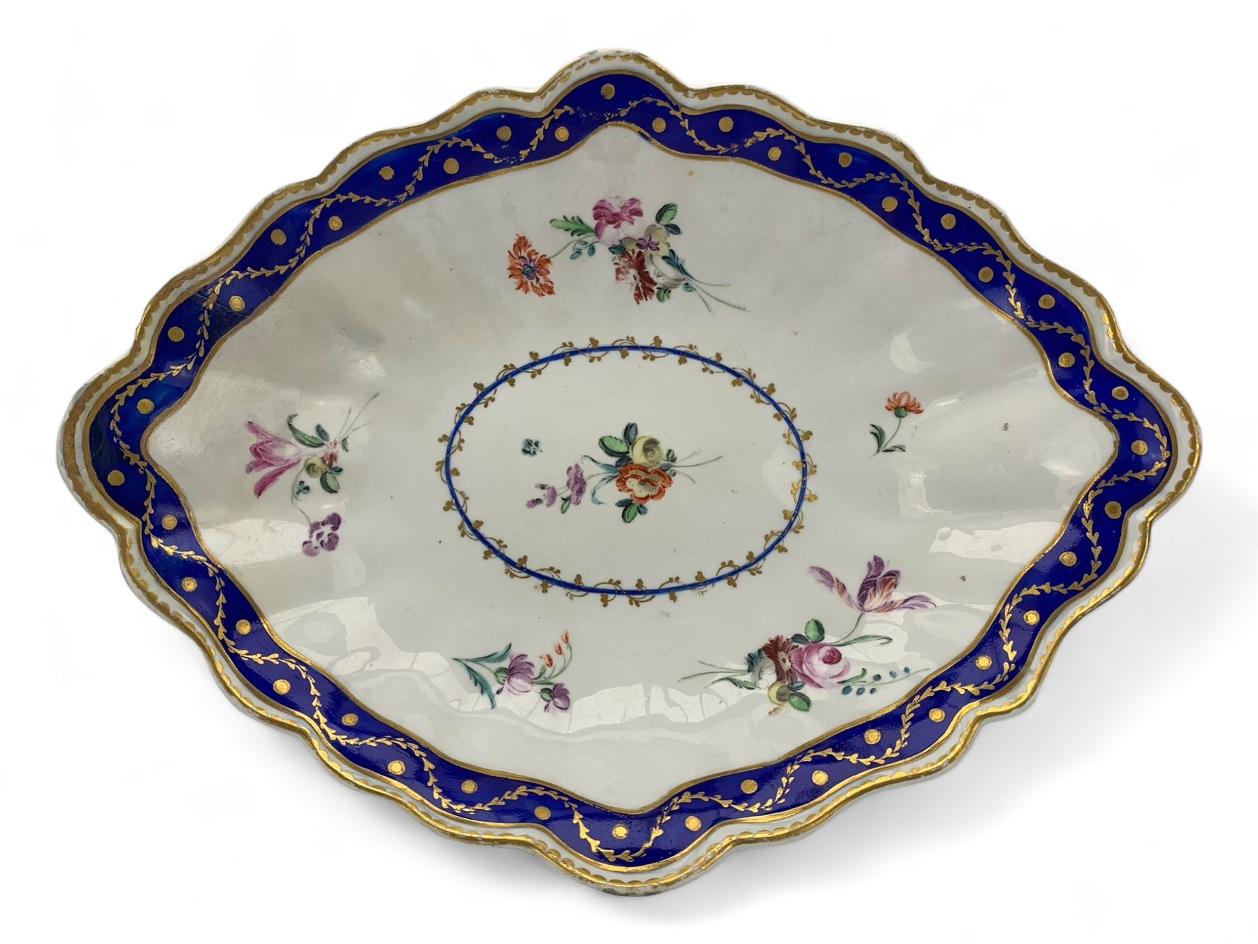 18th century Derby fluted lozenge shaped dish, in the manner of Edward Withers, painted with flower sprays within a blue and gilt leafy chain border, crown over D in blue, incised N, L26cm 