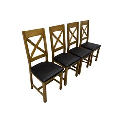 Oak extending dining table, square pull-out action top with folding butterfly leaf, on straight square supports; set of four dining chairs, X-shaped backrest and black upholstered seat, on square supports united by H-stretcher