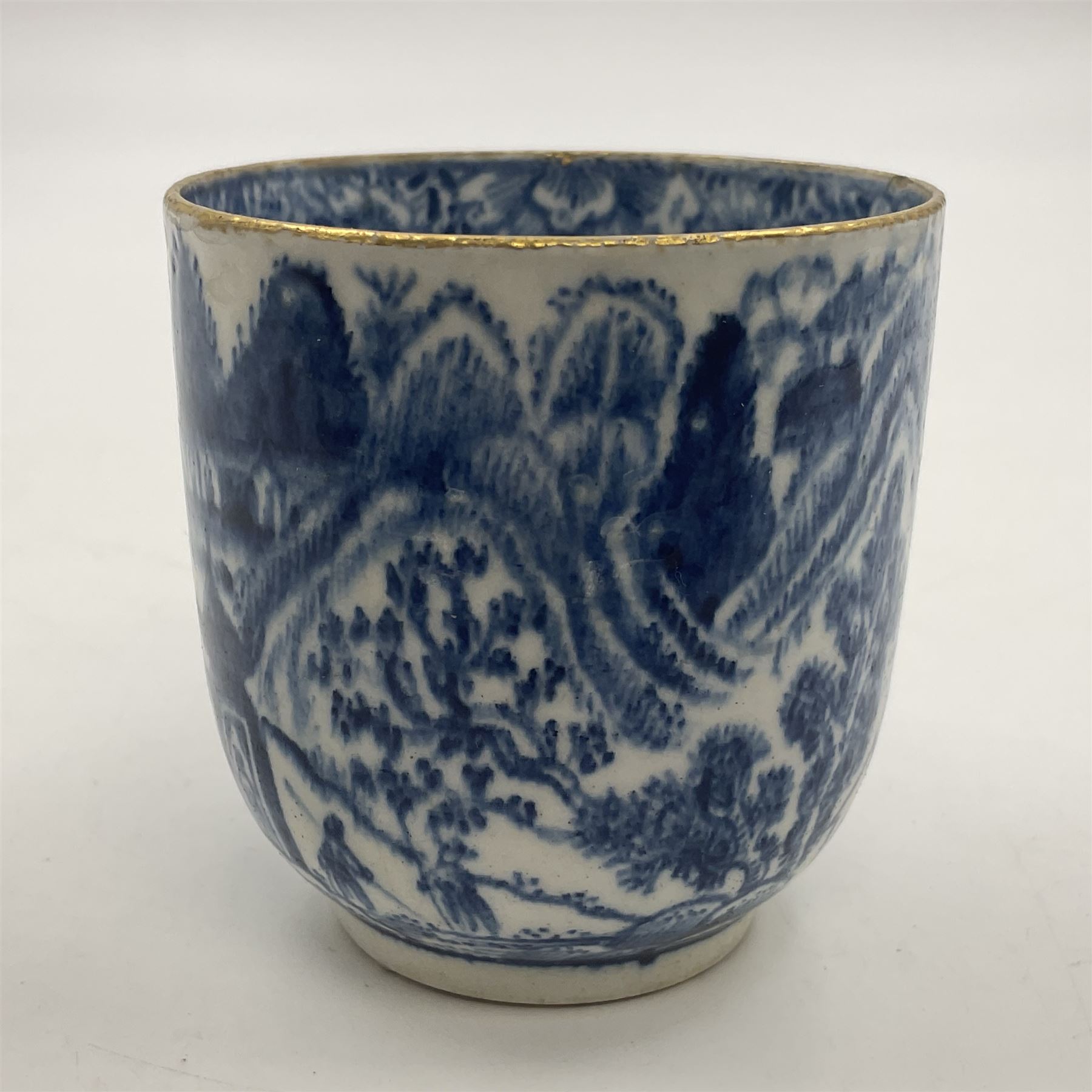 Rare 18th century Bow porcelain coffee cup, circa 1765-1770, profusely decorated with figures and dwellings in a rocky landscape, the interior with wide foliate border, H6cm