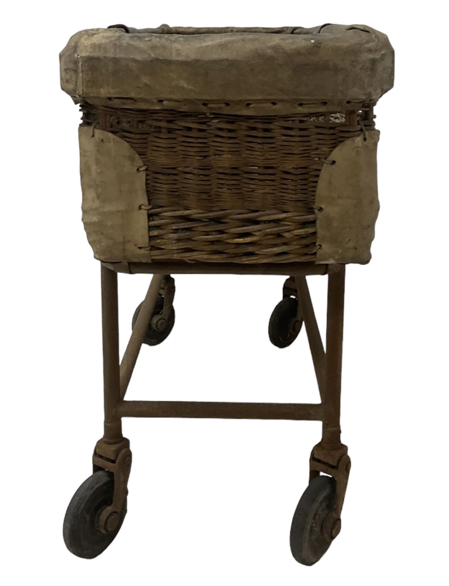 Early 20th century GPO wicker and hide bound postal trolley, on a cast iron base with castors