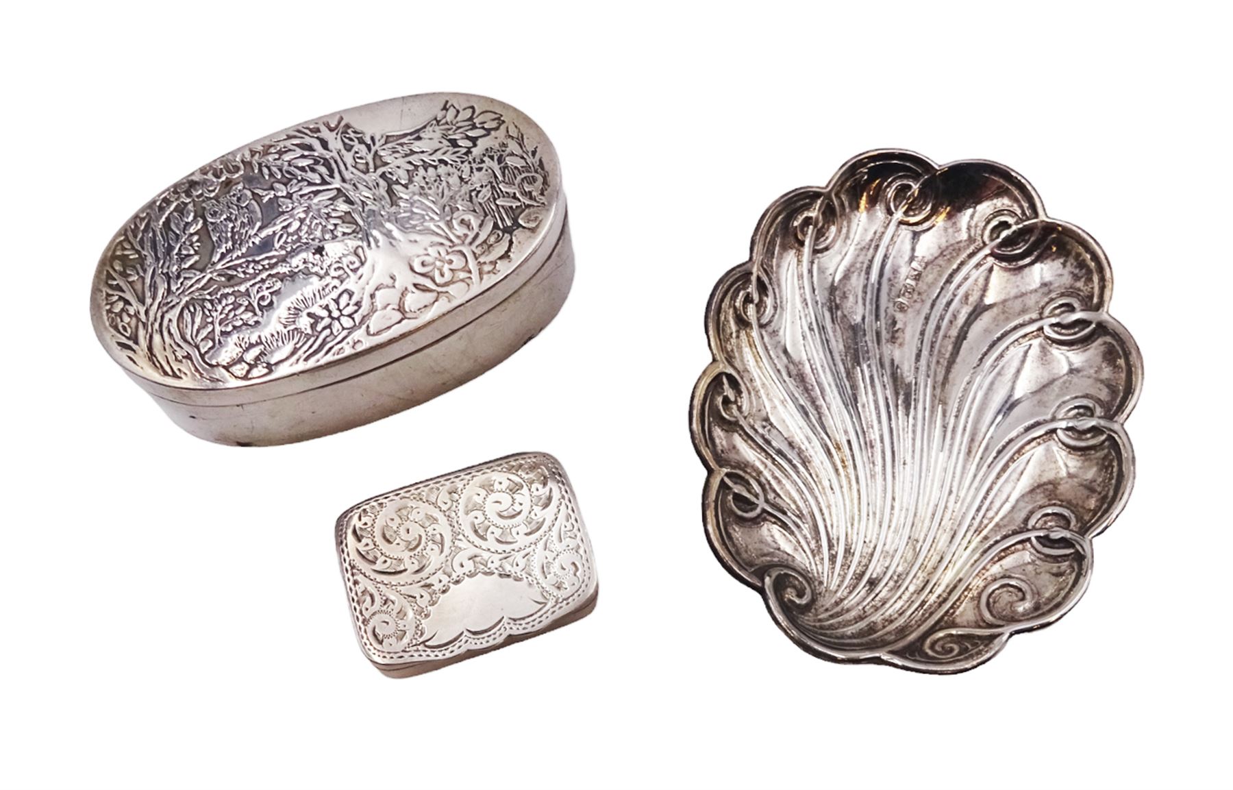 Modern silver oval box, decorated to the removable cover with an owl on a branch, hallmarked London 1984, makers mark KB, together with a modern silver pin tray of scrolling lobed form, hallmarked 1992, makers mark EM, and an early 20th century silver pill box, hallmarked Adie & Lovekin Ltd, Birmingham 1910, oval box H2.2cm, W6.5cm