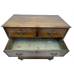 George III oak chest, rectangular top with moulded edge over two short and three long graduated drawers, each with brass escutcheons and shaped backplate handles, on turned bun supports 