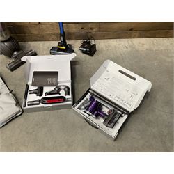 Dyson DC40 vacuum cleaner with various attachments, and a Vax cordless vacuum cleaner with single battery and charger