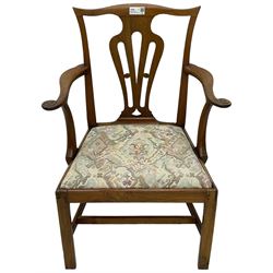 George III walnut elbow chair, shaped cresting rail over shaped pierced splat, the shaped arms with scroll carved terminals, upholstered drop in seat, on square chamfered supports united by plain stretchers 