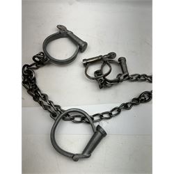 Hiatt handcuff and leg chains, together with leather collar with brass cow bells and similar items 