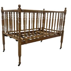 Victorian beech and pitch pine crib, turned spindle gallery supports, raised on square tapering supports with castors