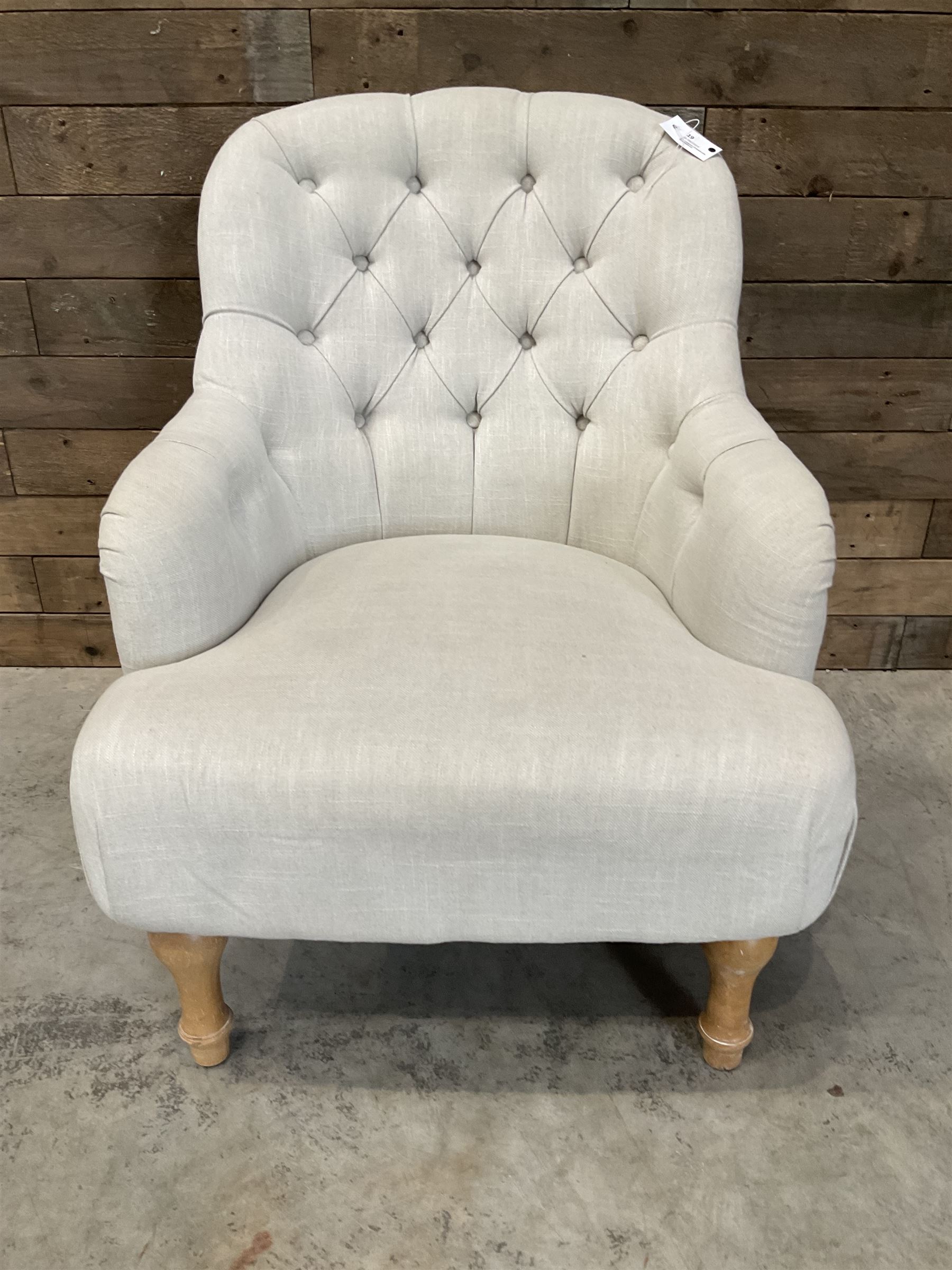 Armchair upholstered in button back linen fabric